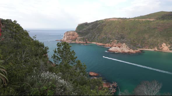 A beautiful summers day overlooking the Knysna HEads from a viewpoint with boats coming in and out o