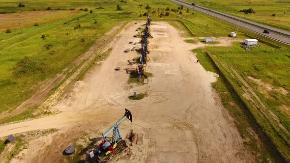 Aerial view of the row of oil derricks in summer