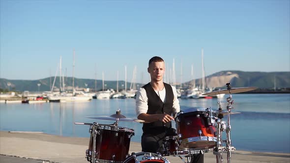 Man Drummer Giving Performance on Waterfront