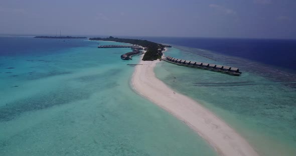 Beautiful flying copy space shot of a summer white paradise sand beach and aqua blue ocean backgroun