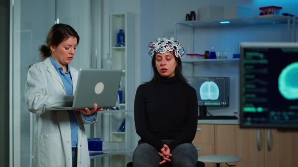 Specialist Neurologist Doctor Taking Notes on Laptop