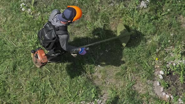 Man Mows the Grass with a Manual Petrol Lawn Mower in Slow Motion