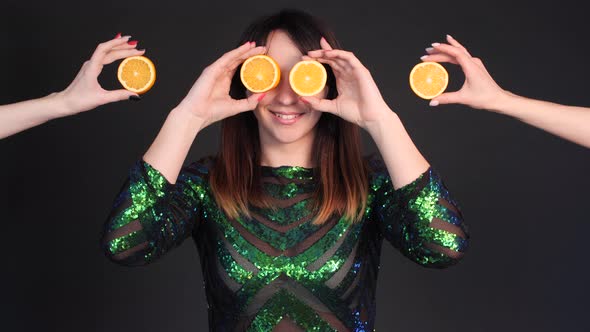 Happy Woman in Bright Dress Posing with Oranges