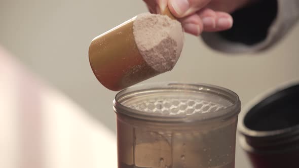 Serving A Portion Of Protein Powder Into The Shaker bottle