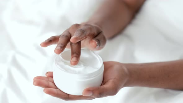 Hands Close Up Black African American Girl Applying Moisturizing Cream and Massage Arm for Softness