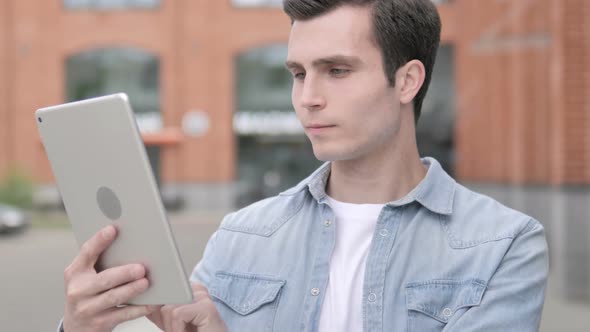 Young Man Using Tablet Outdoor