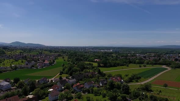 Drone flight over Gundelfingen and Wildtal with view of Freiburg on a sunny day