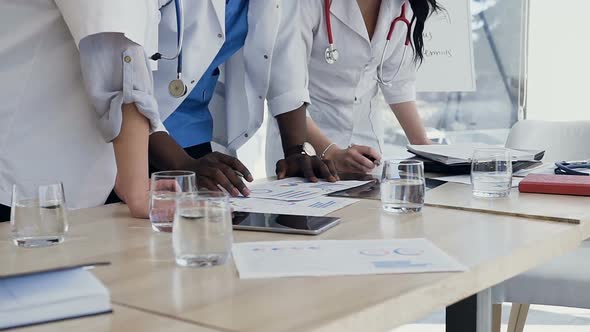 Hands of Three Doctors During Discussing Result 