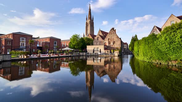 Bruges timelapse showing the Bakkersrei canal and the spire of the Church of Our Lady (Onze Lieve Vr