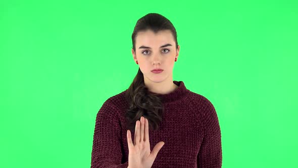 Woman Strictly Gesturing with Hands Shape Meaning Denial Saying NO. Green Screen