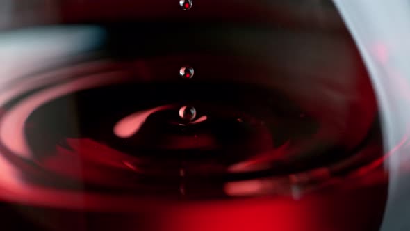 Super Slow Motion Macro Shot of Wine Drop Falling Into Red Wine in Glass at 1000Fps