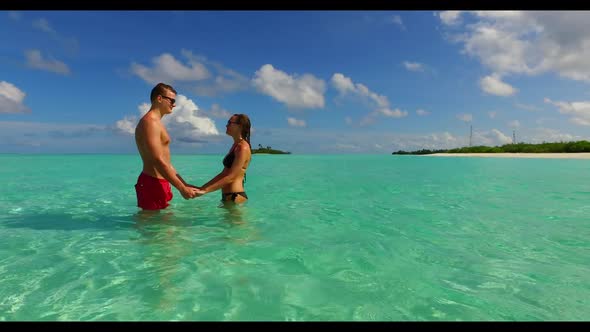 Romantic couple happy together on perfect sea view beach break by blue ocean and bright sandy backgr