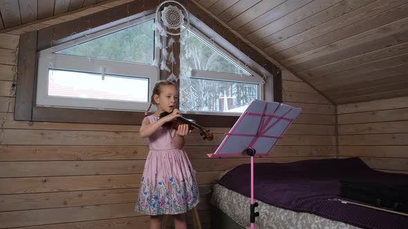 Little Girl Playing Violin in the Attic