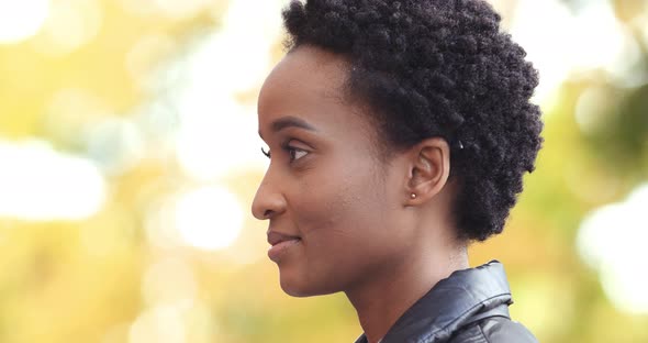 Side Portrait of Short Haired African American Girl Ethnic Woman Standing Alone Outdoors in Profile