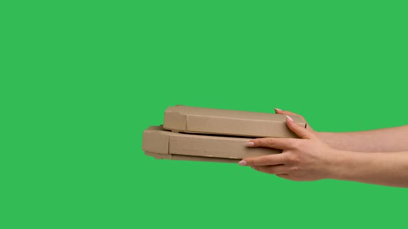 Female Hands Giving Two Cardboard Box with Pizza on Background of Green Screen Chroma Key