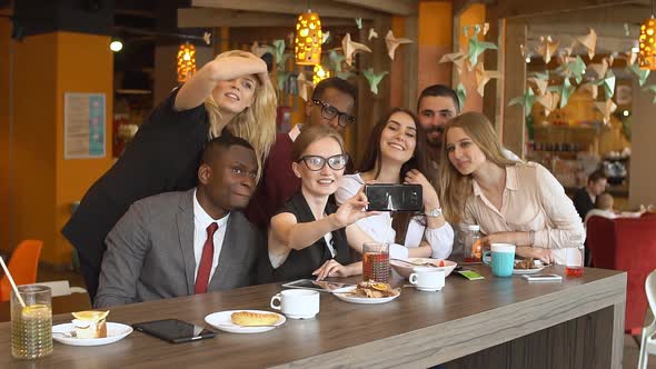 Multinational Group of Friends in a Cafe Doing Selfie