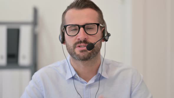 Portrait of Middle Aged Man Talking on Headset