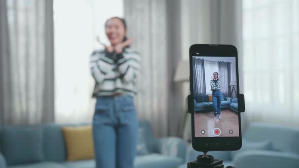 Display Smartphone Of Asian Woman Dancing While Shooting Video Content For Social Networks