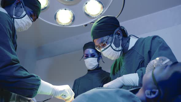 Medical surgical doctor team performing surgery patient