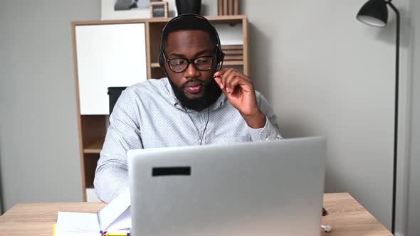 An African Guy Is Using Headset for Work