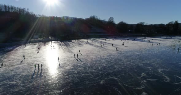 Frozen lake with people iceskating