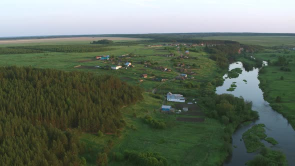 Aerial View of the River with a Rock and Forest on the Banks