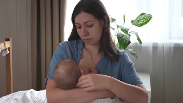 Mother Breastfeeding Baby at Home