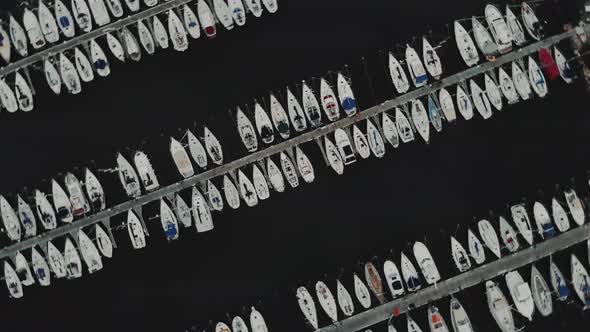 Aerial Drone Flying Out Over a Marina for Boats and Tourist Ships