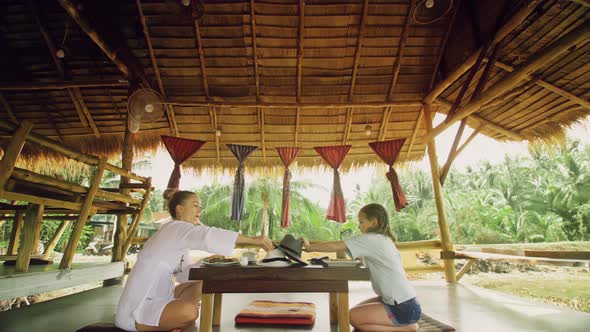 The Happy Family Eat and Drink Tasty Beverages Spending Time in Local Floating Cafe on Water