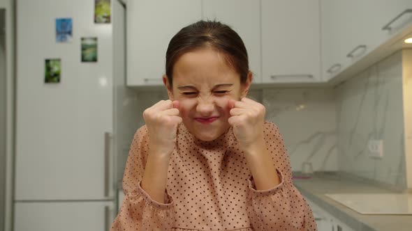 Preteen Girl Clenching Palms Into Fists Expressing Anger Indoors