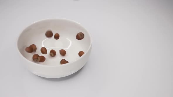 Hazelnuts Fall Into the Plate