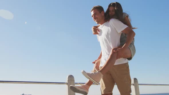 Young adult couple having fun at the seaside