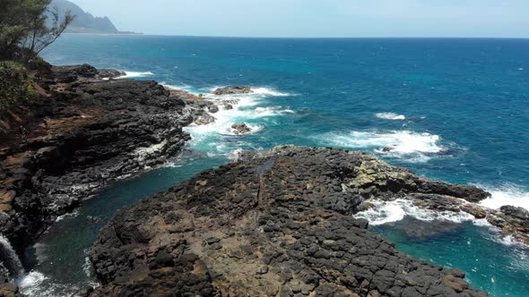 Drone view of the ocean and stone coastline at Kauai, Hawaii, USA