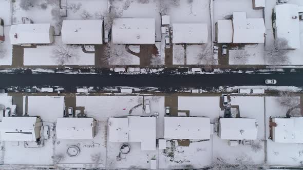 Aerial view looking down at houses and street durning winter