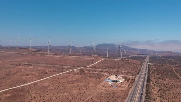 Timelapse of wind turbines and highway in Chile