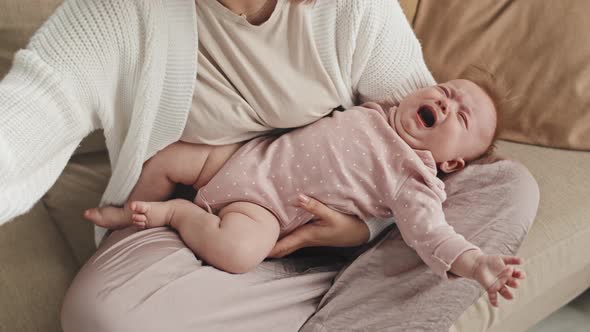 Baby Crying in Arms of Parent