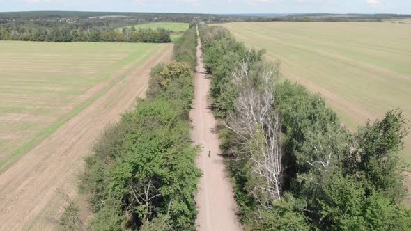 Cyclist rides on bicycle on gravel road