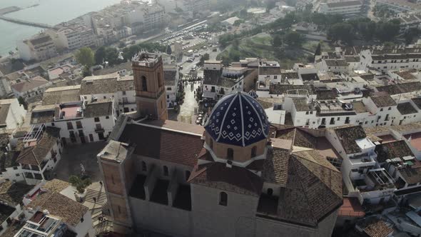 Aerial orbit around blue mosaic dome church, Nostra Senyora del Consol, Altea