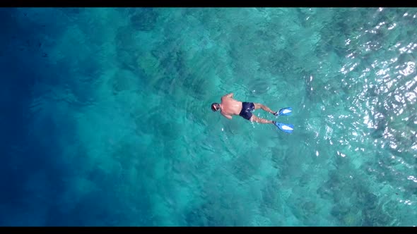 Boy and girl suntan on beautiful tourist beach voyage by blue water and white sandy background of th