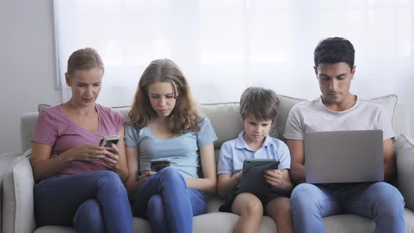 Family Sitting Together Using Electronic Device