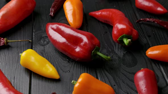 Red Yellow Orange Bell Peppers on a Wooden Cutting Board