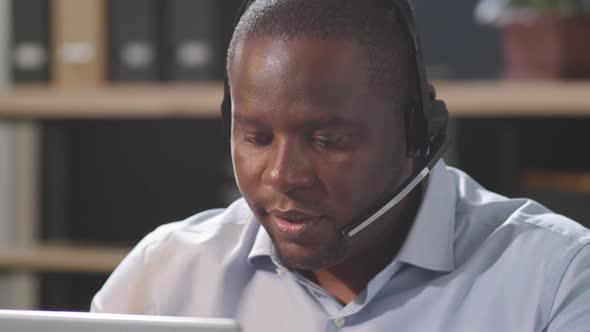 Portrait of Cheerful Black Call Center Agent at Work