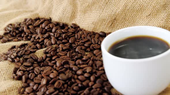 Black coffee served on sack with coffee beans