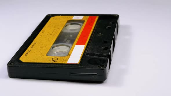 Audio Cassette Rotates on White Background