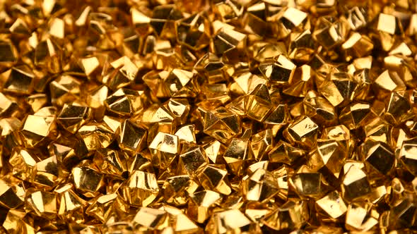 Abstract background of golden nuggets spinning