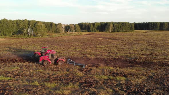 Tractors with  plow plowing the field