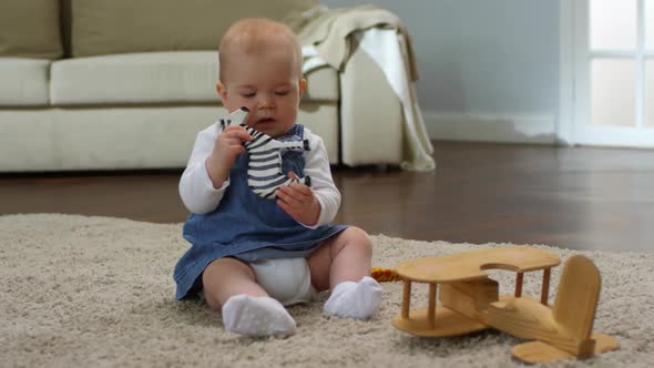 Caucasian Baby Girl Nibbling on Toy