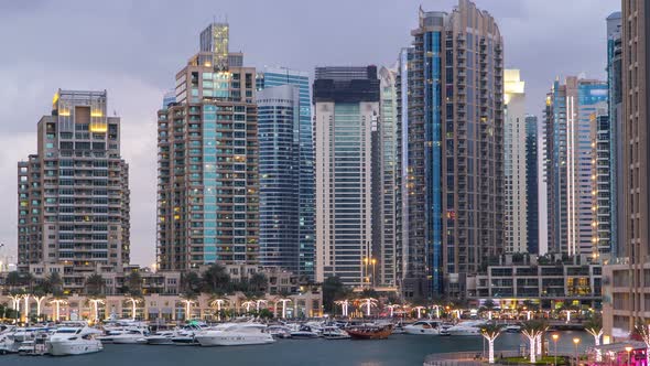 View of Dubai Marina Towers and Canal in Dubai Day to Night Timelapse
