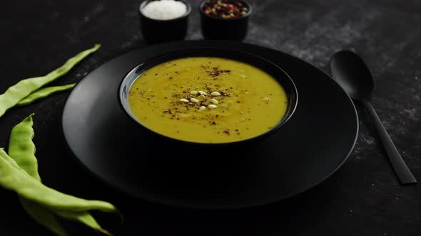 Creamy Soup with Green Pea in a Ceramic White Plate