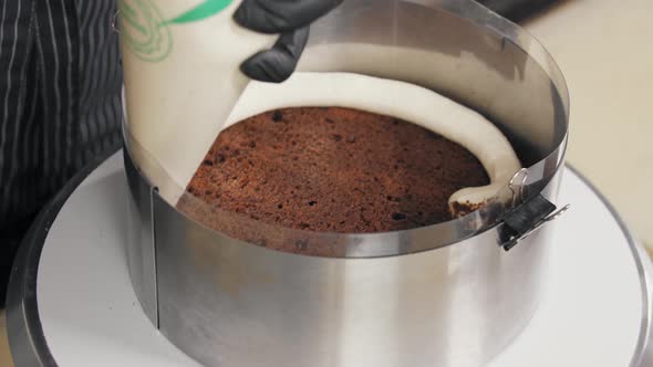 Confectioner Squeezes Vanilla Cream Onto Sponge Cake